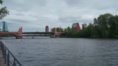Boats sail under a bridge on a cloudy day (Frankfurt) Stock Footage 260220515