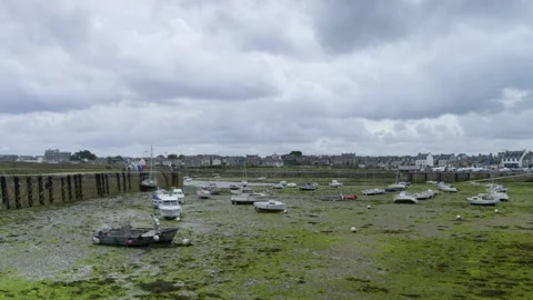 Boats on the sand at low tide in a typical Brittany harbor, in France Stock Footage 229738580