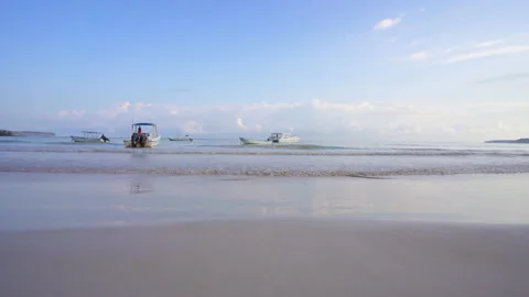 Boats in shallow waters at the beach Stock Footage 137955172