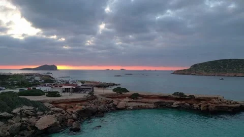 Boats at Sunset at cala comte beach, ibiza. Smooth aerial view flight drone Video stock 274765576