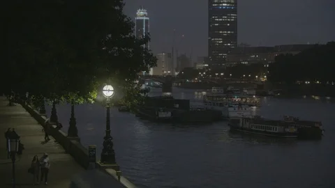 Boats on Thames River. People Walking Along the River Bank Stock Footage 83645982