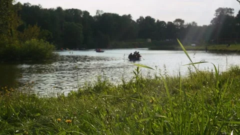 Boats with vacationing people float on the surface of the park pond. Russia.. Stock Footage 282199846