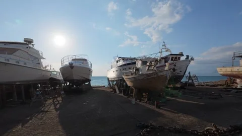Boatyard activity with vessels on land preparing for summer travel Stock Footage 337048410