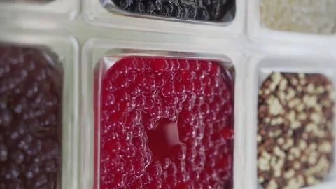 Bobas of different flavors for the preparation of bubble tea drink on Stock Footage 258996134