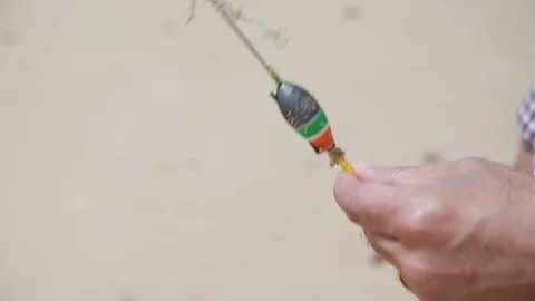 Bobber lying in mans hands Stock Footage 111433163