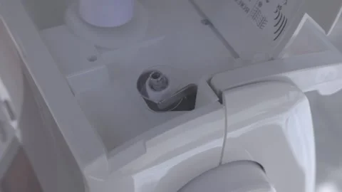 Bobbin being filled with white thread ready to use on a sewing machine 動画素材 312156803