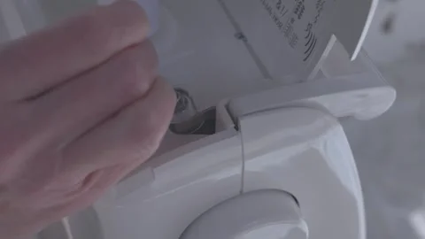 Bobbin being threaded with white thread on a sewing machine Stock Footage 312156824