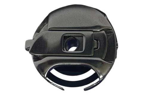 Bobbin case for vertical hook. Part from a sewing machine Stock Photos