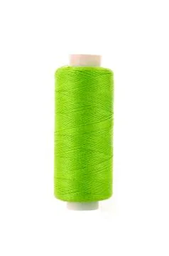 Bobbin with green thread over white background Stock Photos
