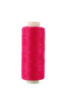 Bobbin with red thread over white background Stock Photos