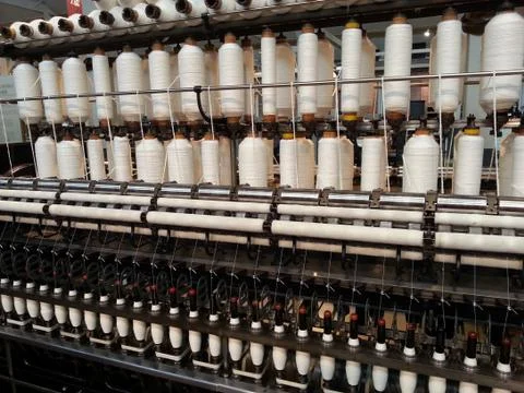 Bobbin thread cones on a warping machine in a textile mill 스톡 사진