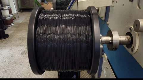 Bobbin winding machine. Detail from a spool with plastic filament Stock Footage 150274928