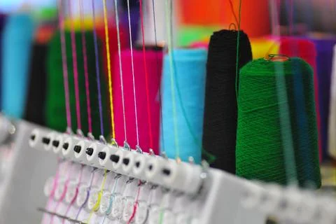 Bobbins with colored thread for industrial textile machines Stock Photos