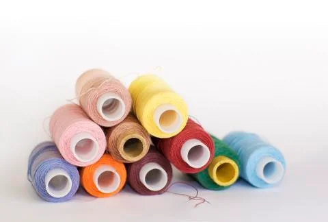 Bobbins of different colored threads Stock Photos
