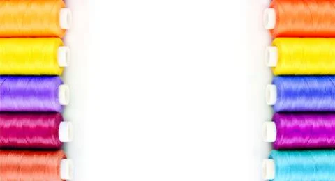 Bobbins of multicolor thread over white background Foto stock