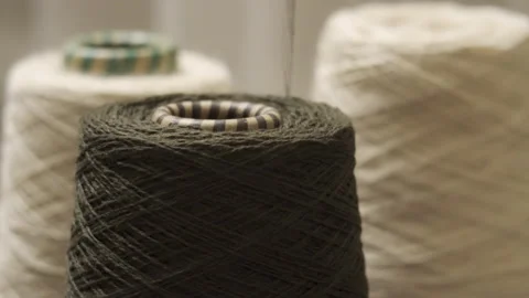 Bobbins with yarn for a knitting machine close-up. Knitted clothes handmade Видео 218388975