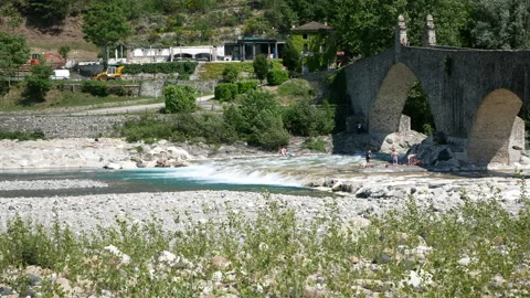 Bobbio, View of the river "Trebbia" and the famous bridge "Gobbo" ( hunchbacked) Stock Footage 134558289