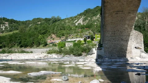 Bobbio, View of the river "Trebbia" and the bridge "Gobbo" ( hunchbacked) Stock Footage 134559402