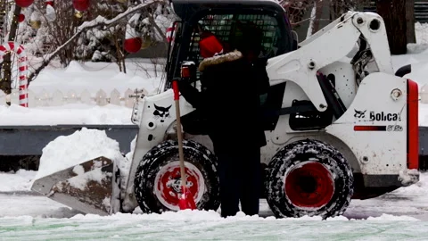 Bobcat, compact snow removal, moving fast and collects the snow Stock Footage 168828779