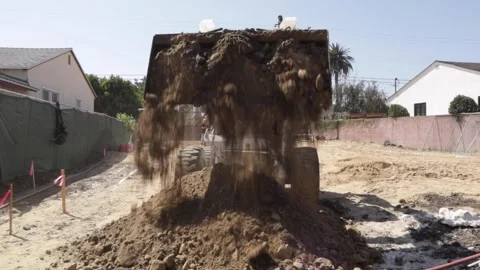 Bobcat dumping dirt at a construction yard in slow motion Stock-Footage 228794759
