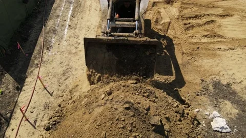 Bobcat dumping dirt in a pile in slow motion Stock-Footage 228794889
