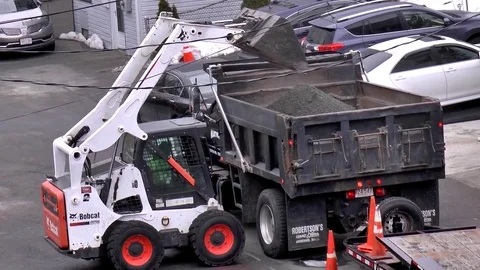 Bobcat front loader tractor, moves dirt gravel to dump truck Stock Footage 74168288