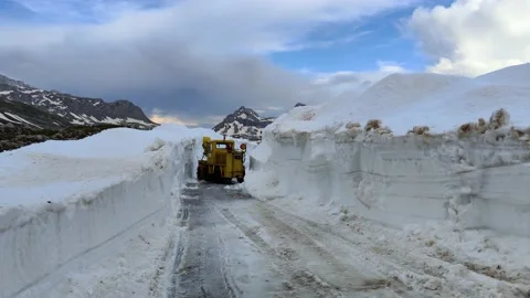 Bobcat machine, skid steer cleaning high snow on the road. Harsh winter Stock Footage 220519905
