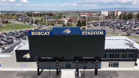 Bobcat Stadium scoreboard displays bold blue and gold signage above Montana Stock Footage 339985670