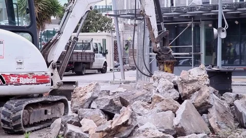 Bobcat tractor break down cement blocks with pneumatic hammer Hydraulic Breaker Stock Footage 71322436