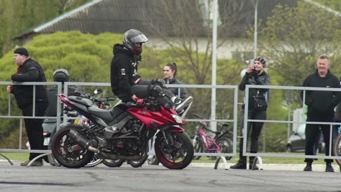 Bobruisk, Belarus 01.05.26: Motorcyclist performs daring stunt maneuver with red Stock Footage 339865419