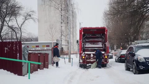 Bobruisk, Belarus - 12.02.23: Workers remove garbage from a trash can to a Stock Footage 291779018