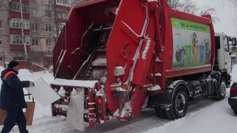 Bobruisk, Belarus - 12.02.23: Workers remove garbage from a trash can to a Stock Footage 295604737