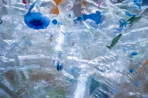 Bodegon of plastic bottles creating a sea with paper fish Stock Photos