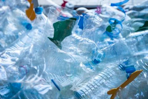 Bodegon of plastic bottles creating a sea with paper fish Stock Photos