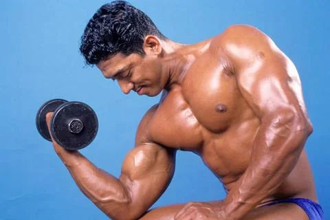 Body Builder doing Exercise Copyright: xRxModi/DinodiaxPhotox  Stock Photos