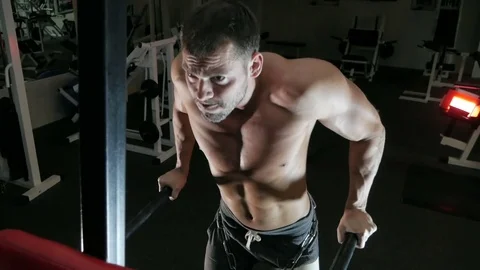 Body-builder is engaged on horizontal bars Stock Footage 75807454