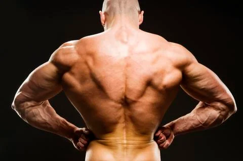 Body Builder Posing - Rear Lat Spread. Strong man flexing muscles Fotos de archivo
