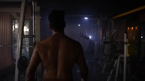 Body builder walking in a gym Stock Footage 247285318