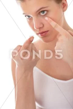 Body care - young woman apply contact lens Stock Photos