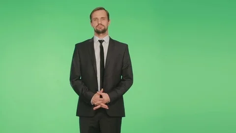 Body language. a man in a business suit on a green background Stock Footage 70543853