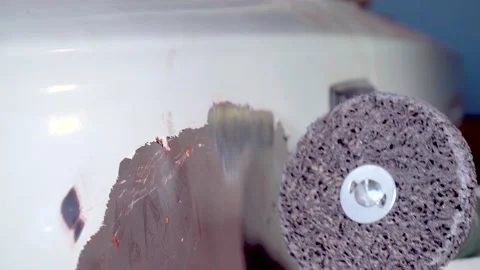 Body master grind old paint from car body using drill with scotch brite circle Stock Footage 133201238