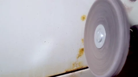 Body master grind old paint from car body using drill with scotch brite circle Stock Footage 133737684