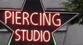 Body Piercing Studio Neon Sign Light Street Outdoor Signage Colorful Advertising HD Footage