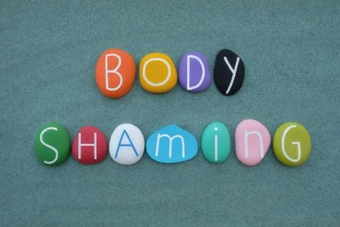 Body shaming, creative composition with multicolored stone letters Stock Photos