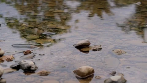 A body of water with rocks in it 스톡 동영상 319296380