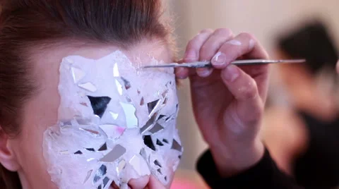 BodyArt Master makes mask on face model Stock Footage 58153355