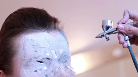 BodyArt Master makes mask on face model Stock Footage 58155293
