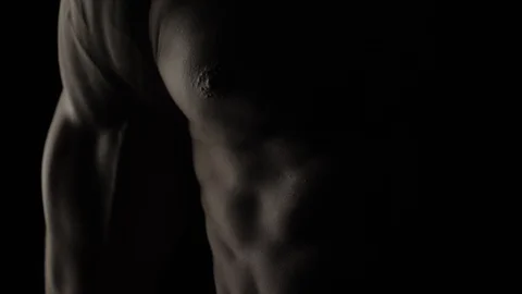 Bodybuilder Against Black Background Video stock 128346306