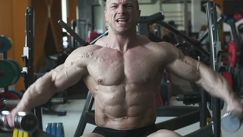 Bodybuilder athletic man workout muscles exercise Video stock 127873614