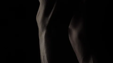 Bodybuilder on black background Stock Footage 128346474